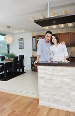 Image showing happy young couple have fun in modern kitchen