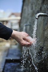 Image showing fresh mountain water falling on hands