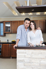 Image showing happy young couple have fun in modern kitchen