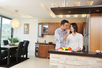 Image showing happy young couple have fun in modern kitchen