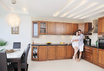 Image showing happy young couple have fun in modern kitchen