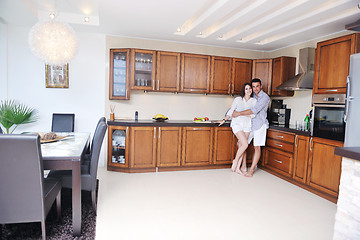 Image showing happy young couple have fun in modern kitchen