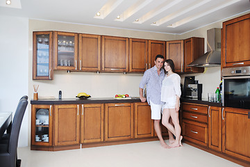 Image showing happy young couple have fun in modern kitchen