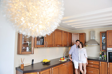 Image showing happy young couple have fun in modern kitchen