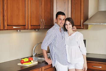 Image showing happy young couple have fun in modern kitchen