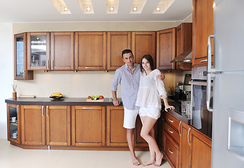 Image showing happy young couple have fun in modern kitchen