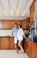 Image showing happy young couple have fun in modern kitchen