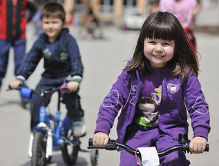 Image showing happy childrens group learning to drive bicycle