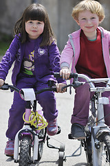 Image showing happy childrens group learning to drive bicycle