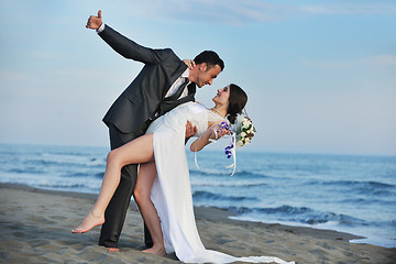 Image showing romantic beach wedding at sunset