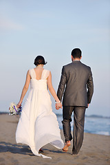 Image showing romantic beach wedding at sunset