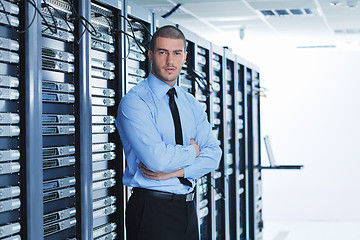 Image showing young it engeneer in datacenter server room