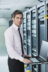 Image showing young it engeneer in datacenter server room