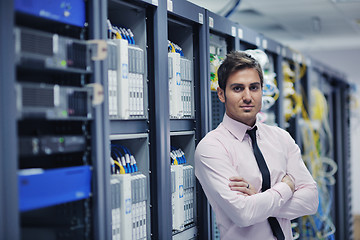 Image showing young it engeneer in datacenter server room