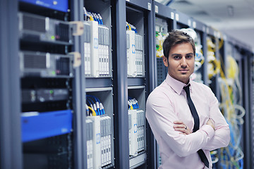 Image showing young it engeneer in datacenter server room