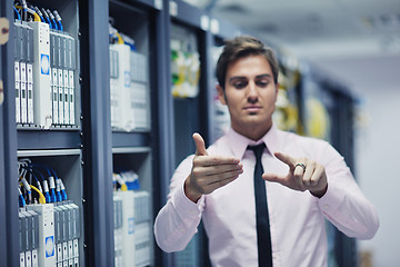 Image showing young it engeneer in datacenter server room