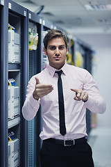 Image showing young it engeneer in datacenter server room