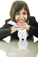 Image showing business woman putting coins money in piggy bank