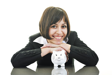 Image showing business woman putting coins money in piggy bank