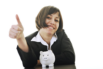 Image showing business woman putting coins money in piggy bank