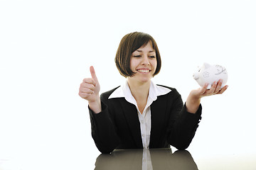 Image showing business woman putting coins money in piggy bank