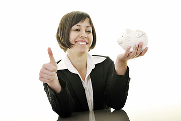 Image showing business woman putting coins money in piggy bank