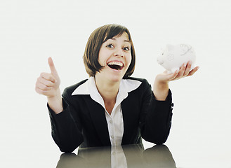 Image showing business woman putting coins money in piggy bank
