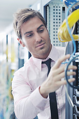 Image showing young it engeneer in datacenter server room