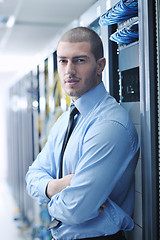 Image showing young it engeneer in datacenter server room