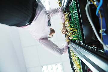 Image showing young it engeneer in datacenter server room