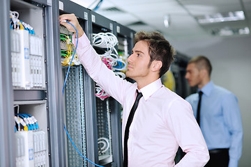 Image showing it engineers in network server room