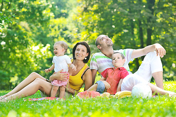 Image showing happy young couple with their children have fun at park