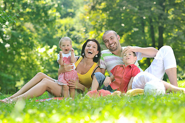 Image showing happy young couple with their children have fun at park