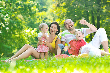 Image showing happy young couple with their children have fun at park