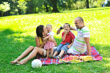 Image showing happy young couple with their children have fun at park