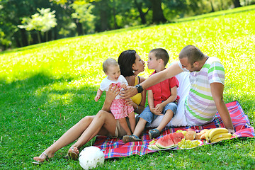 Image showing happy young couple with their children have fun at park