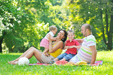 Image showing happy young couple with their children have fun at park