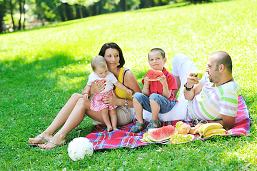 Image showing happy young couple with their children have fun at park