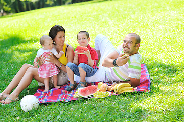 Image showing happy young couple with their children have fun at park