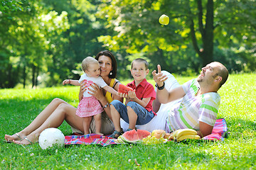 Image showing happy young couple with their children have fun at park