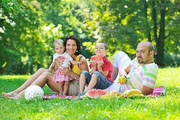 Image showing happy young couple with their children have fun at park