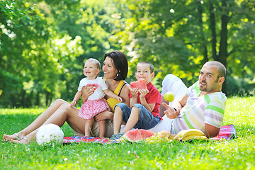 Image showing happy young couple with their children have fun at park