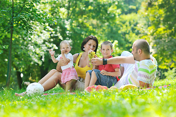 Image showing happy young couple with their children have fun at park