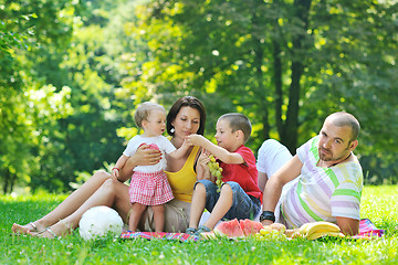 Image showing happy young couple with their children have fun at park