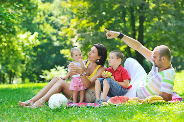 Image showing happy young couple with their children have fun at park