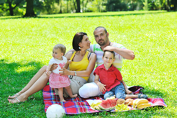 Image showing happy young couple with their children have fun at park