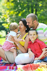 Image showing happy young couple with their children have fun at park