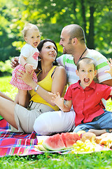 Image showing happy young couple with their children have fun at park