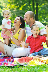 Image showing happy young couple with their children have fun at park