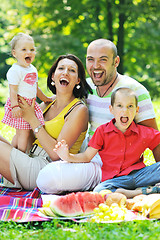 Image showing happy young couple with their children have fun at park